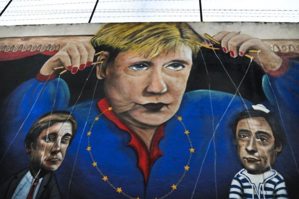 Graffiti depicting Angela Merkel as a puppet master. Photo: AFP