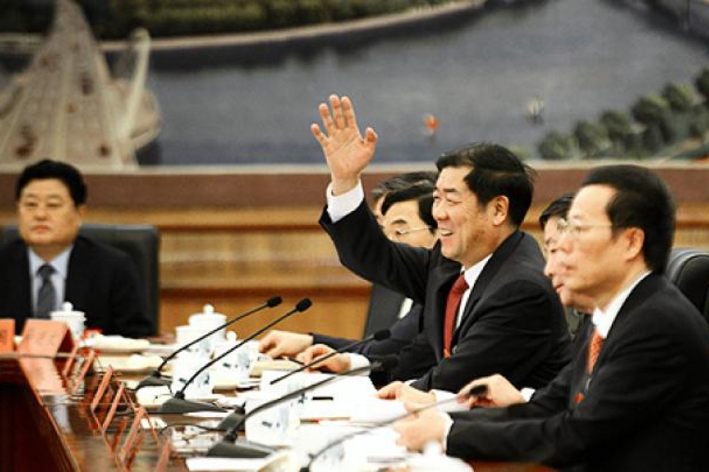 A delegate raises his hand to speak at a panel discussion of the Tianjin delegation on Friday. Photo: AFP