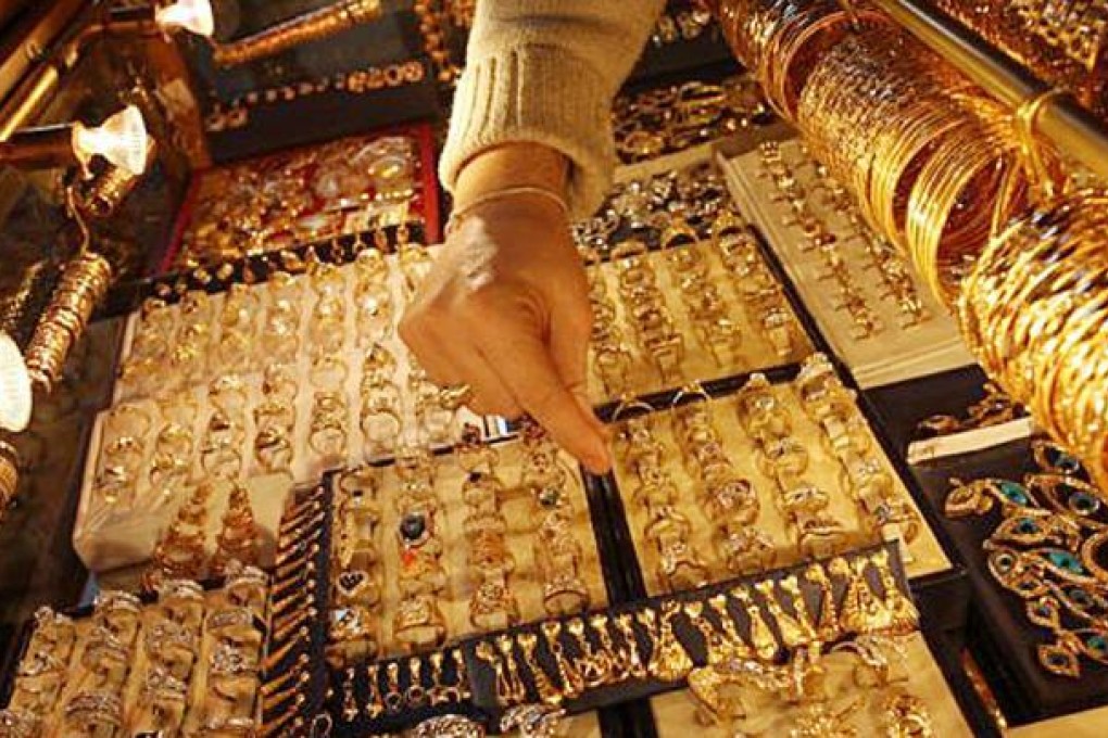 A woman examines gold rings in Damascus. Photo: SCMP Pictures