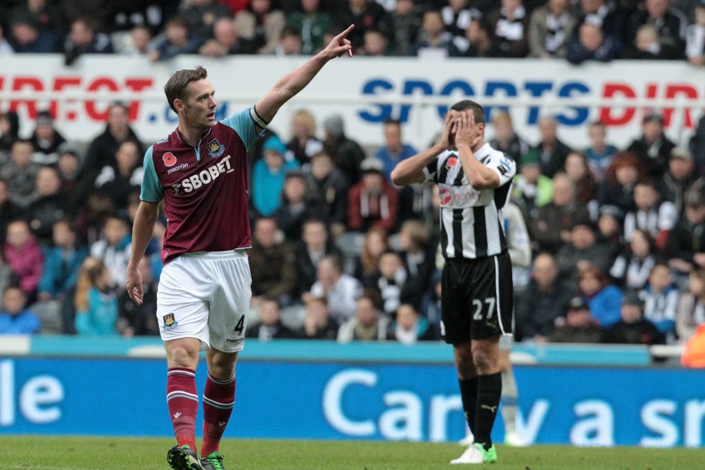 West Ham midfielder Kevin Nolan celebrates his goal as Newcastle United defender Steven Taylor looks on in dismay. Photo: AFP