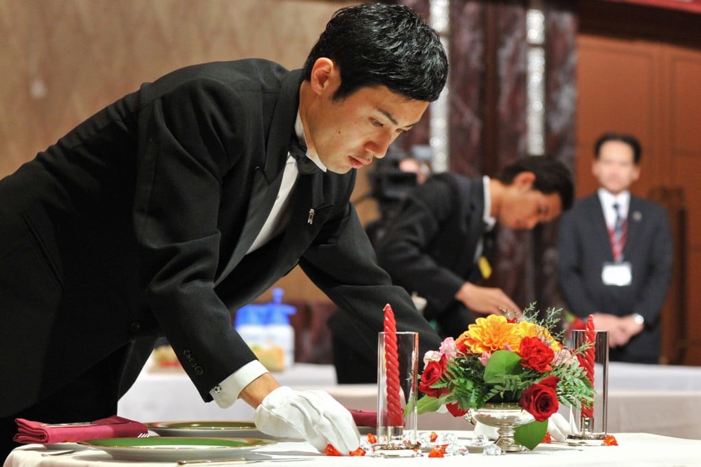 Shin Miyazaki of Japan sets a table during the International Georges Baptiste Cup competition in Tokyo. Photo: AFP