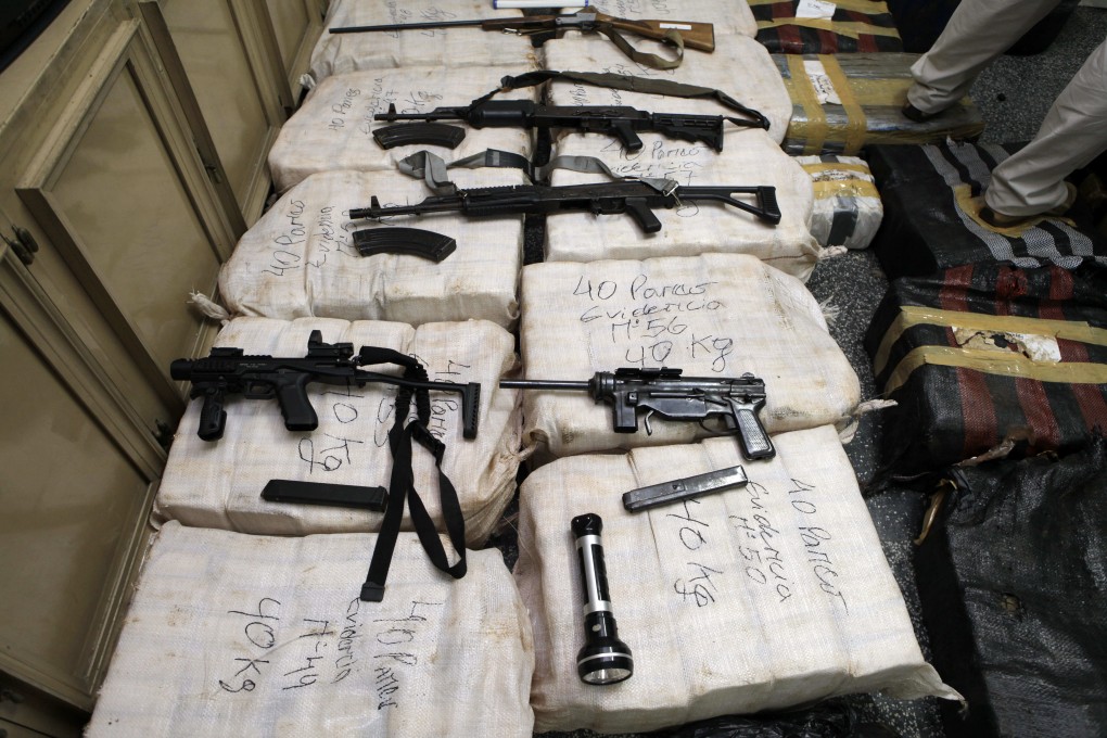 Seized packages containing cocaine and weapons are shown to the press in Asuncion, Paraguay, on November 11, 20120. Photo: AFP