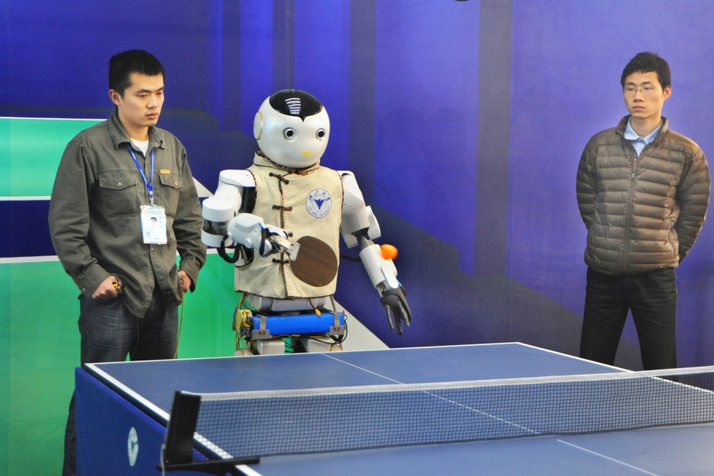 A robot, invented by Zhejiang University, plays table tennis with visitors at the 2012 China International Industry Fair on November 6, 2012. Photo: AFP