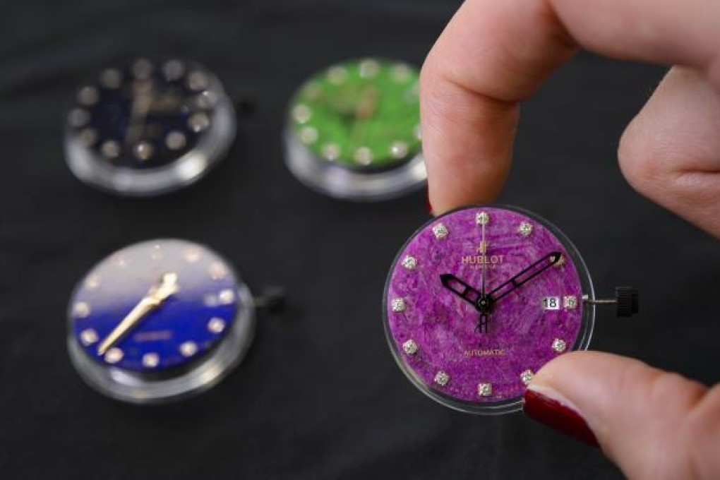 An employee of Swiss watchmaker Hublot holds a watch intended for the Chinese market. Photo: AFP