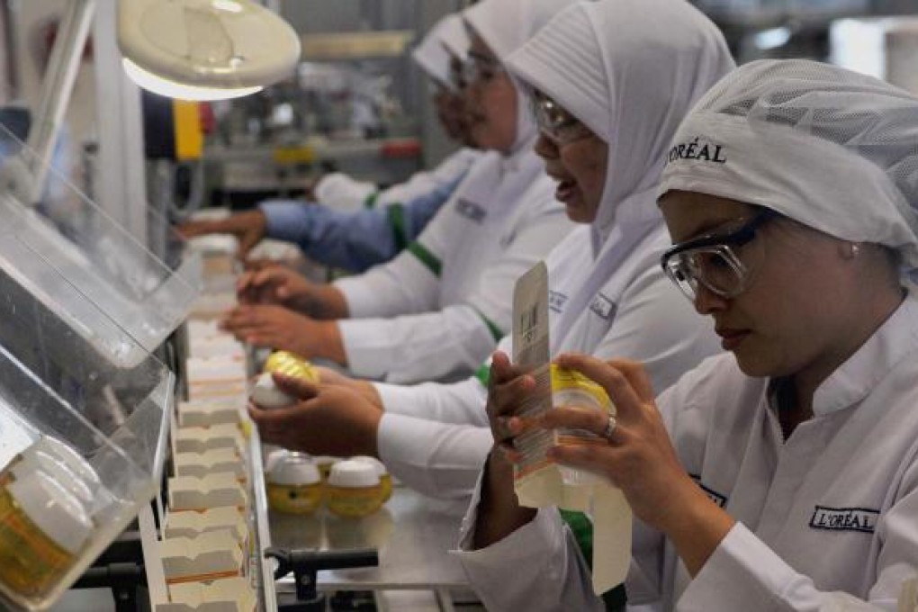 Workers pack cosmetic products at a factory in Jakarta. Indonesia aspires to become an Asian manufacturing centre. Photo: Xinhua