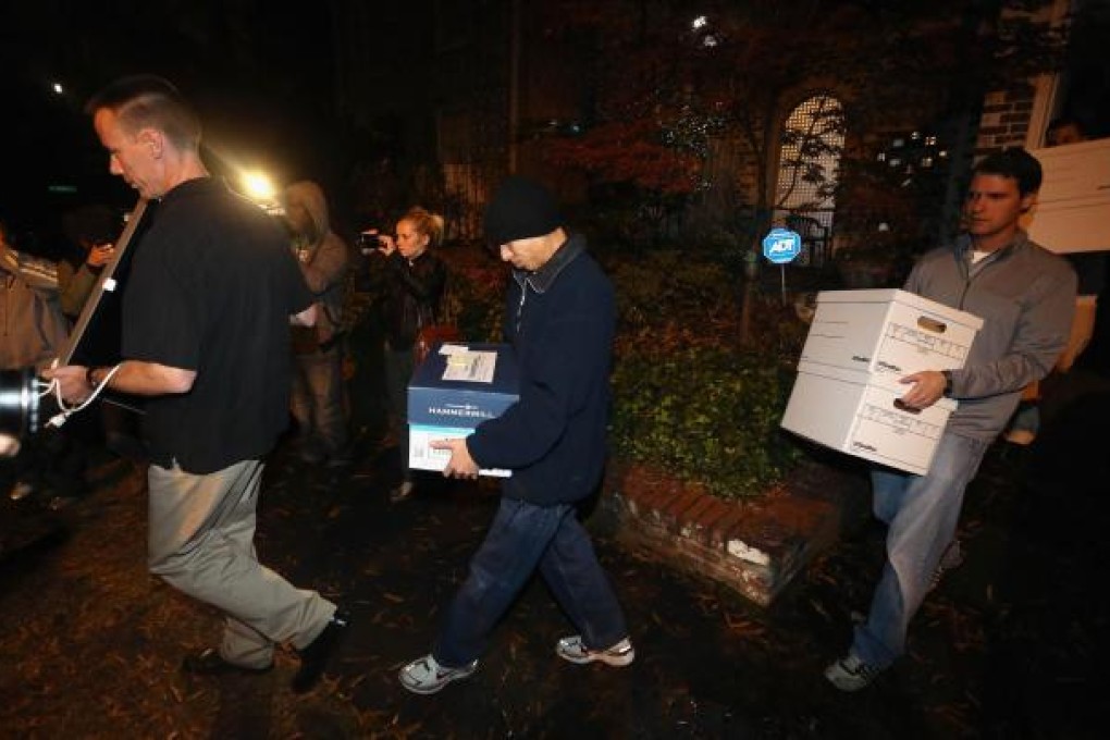 Federal agents carrying boxes of evidence from the home of Paula Broadwell in Charlotte, North Carolina. Photo: AFP