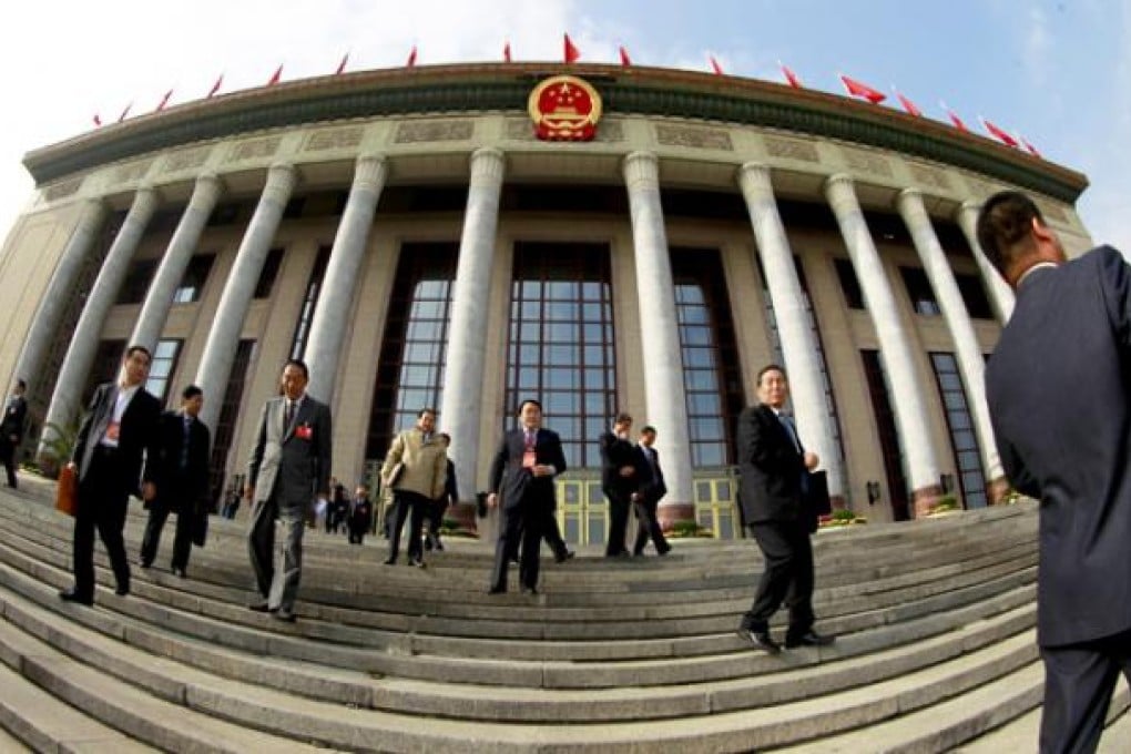Delegates exit the Great Hall of the People followiing a series of 'Open Delegation Discussions' for journalists on Friday. Photo: EPA