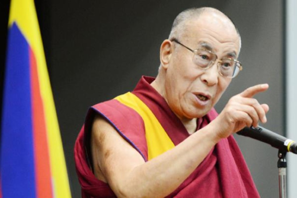 Tibet's spiritual leader the Dalai Lama gestures as he delivers a speech at the upper house members' office building in Tokyo on Tuesday. Photo: AFP