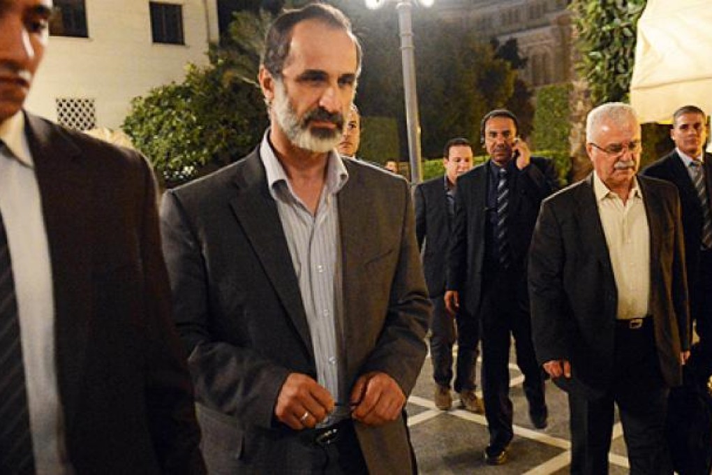 The National Coalition’s newly installed leader Ahmed Moaz al-Khatib (centre) at Arab League headquarters in Cairo on Monday. Photo: AFP