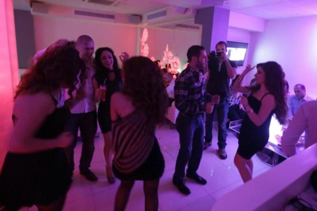 Damascenes dance at a club in the capital, a welcome respite from the turmoil of the civil war. Photo: AFP