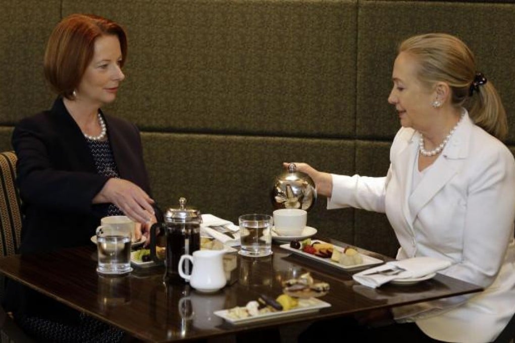 Prime Minister Julia Gillard (left) has a cup with Hillary Clinton in Perth. Photo: AFP