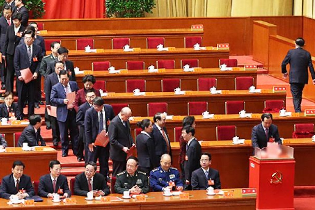 Delegates line up to cast their ballots during the closing session of the party congress. Photo: Xinhua