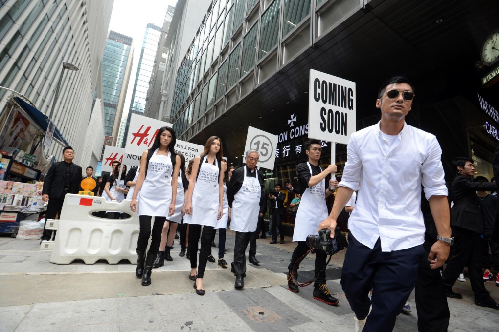 Shawn Yue (front), Pakho Chau and Kenneth Tsang lead the way during the parade through Central at the weekend.