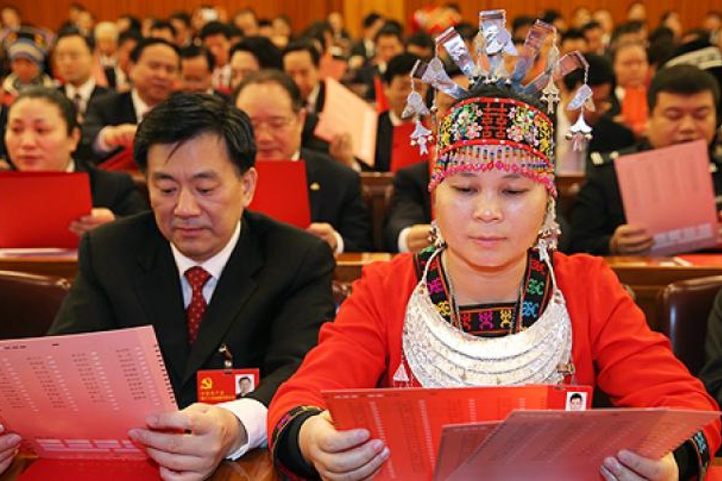 Party delegates peruse their ballots during the closing session of the party congress on Wednesday. Photo: Xinhua