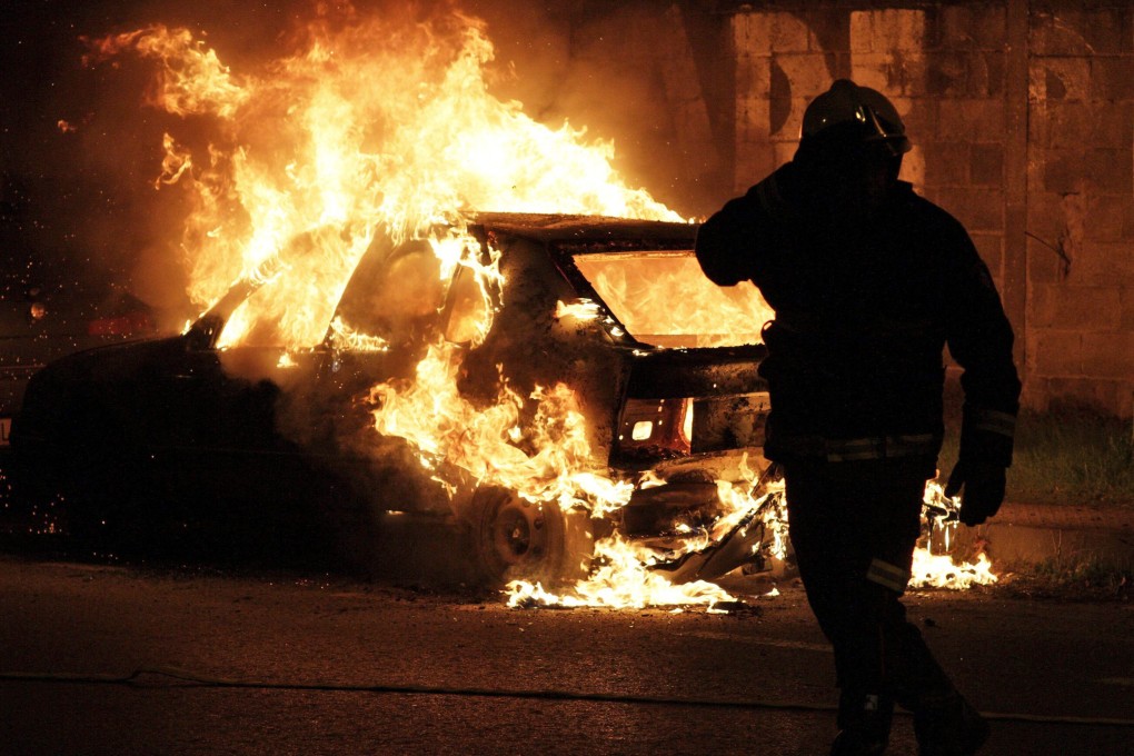 A car is engulfed in flames at an industrial estate in Lugo, northwestern Spain, during a general strike on Wednesday. Photo: EPA