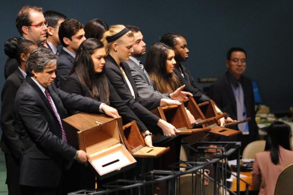 UN staff check the ballot boxes yesterday before the election for members of the United Nations Human Rights Council in New York. Photo: Xinhua