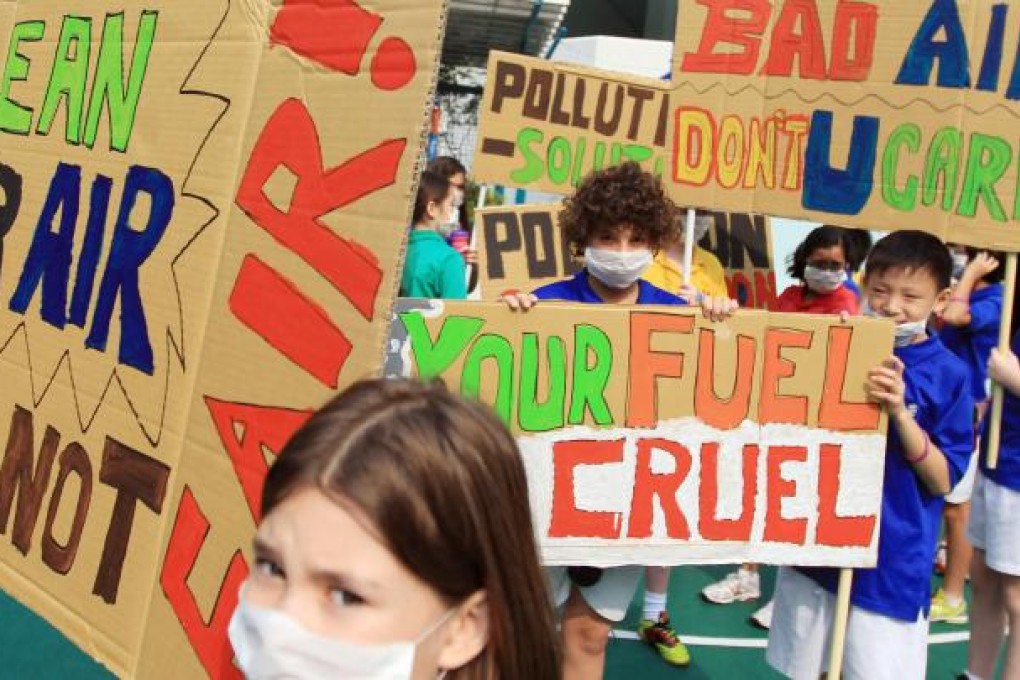 Children from Kennedy School in Pok Fu Lam don face masks to campaign for shipping companies to switch to low-sulphur fuel in Hong Kong waters. Photos: Jonathan Wong, Sam Tsang