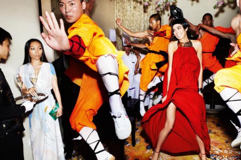 Model Karlie Kloss (right) and jewellery designer Bao Bao Wan (left), with Shaolin monks at the Pangu Plaza, Beijing, in 2011. Pictures: Copyright © Mario Testino