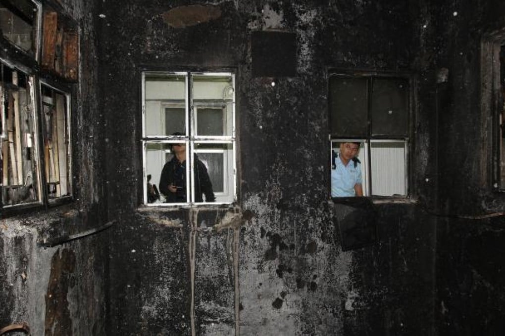 Investigators inspect Chung Hing Mansion yesterday. Seven hundred residents were evacuated during the fire. Photo: Dickson Lee