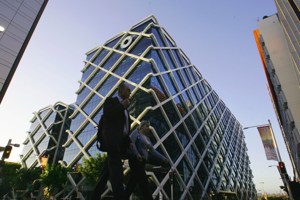 Pedestrians walk past the offices of Macquarie Group Ltd. bank in Sydney on Oct. 25, 2010. Photo: Bloomberg