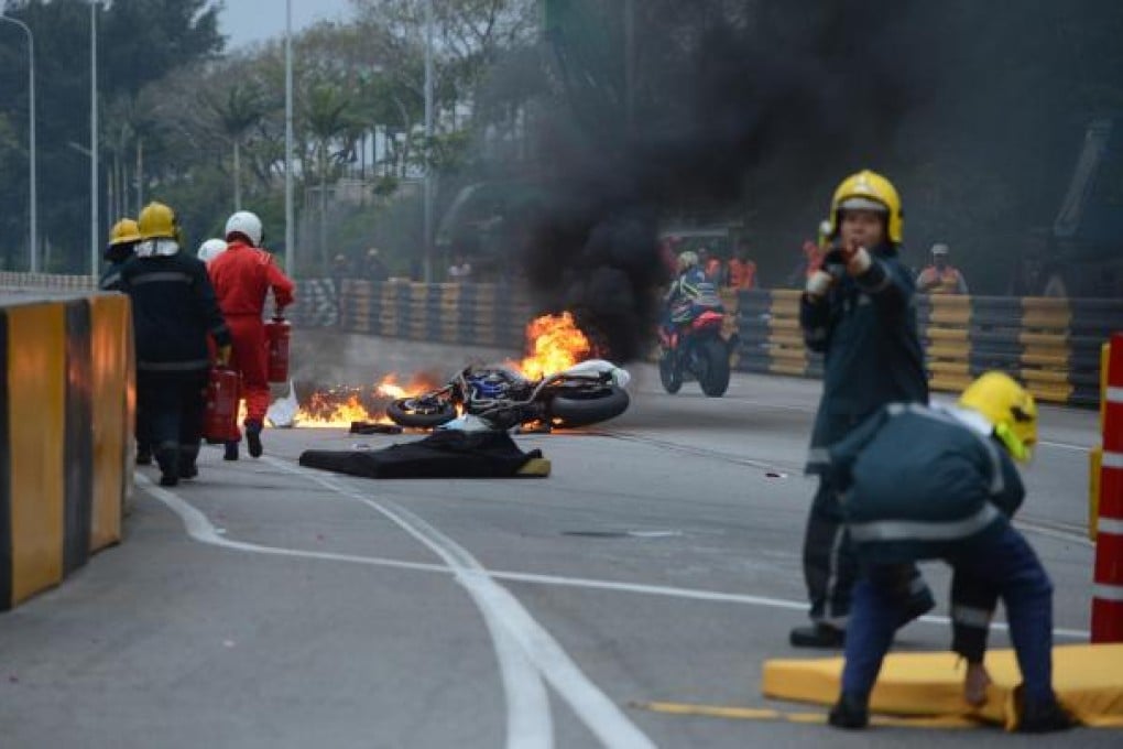 Firefighters rush to put out the flames engulfing Luis Carreira's bike. Photo: Xinhua