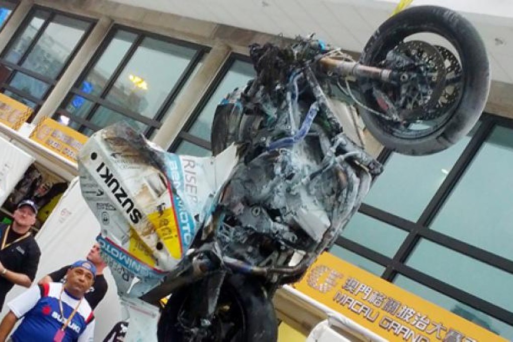 The motorcycle of Luis Filipe de Sousa Carreira is removed the Macau Motorcycle Grand Prix course after his fatal crash.  Photo: James Porteous