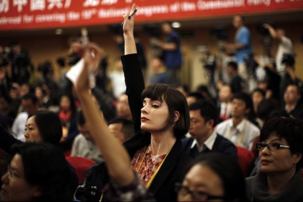 Australian journalist Andrea Yu raises her hand to ask a question at a  news conference during the 18th  Party Congress in Beijing on November 12, 2012. Photo: Reuters
