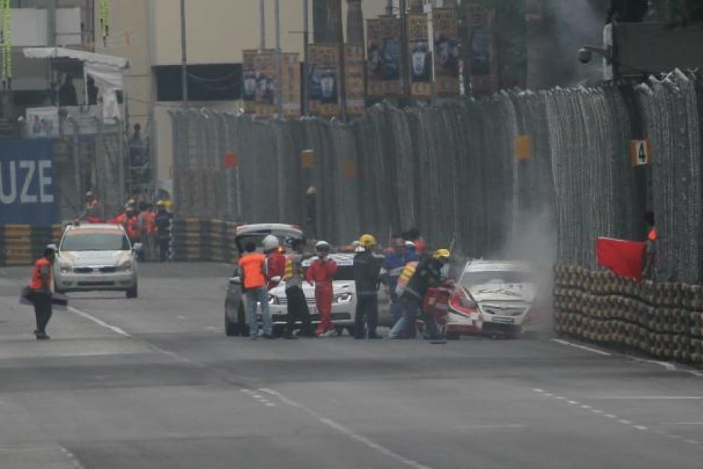 Rescuers rush to save Phillip Yau after he crashed. It took six minutes to cut him from the wreckage. Photo: Xinhua
