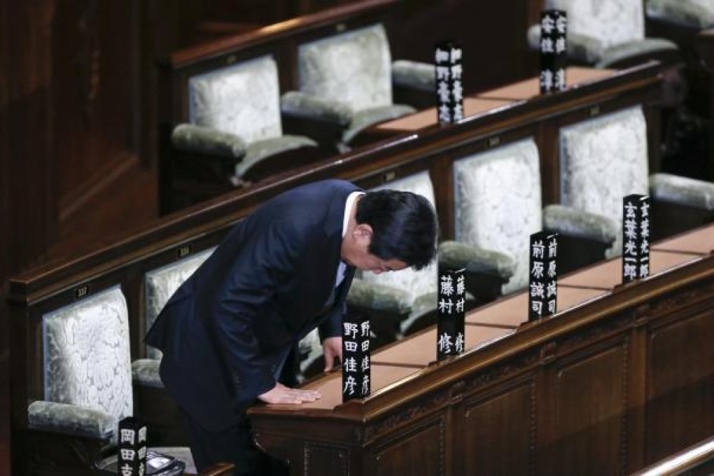 Yoshihiko Noda bows as he takes his seat in Japan's lower house chamber yesterday. Photo: EPA