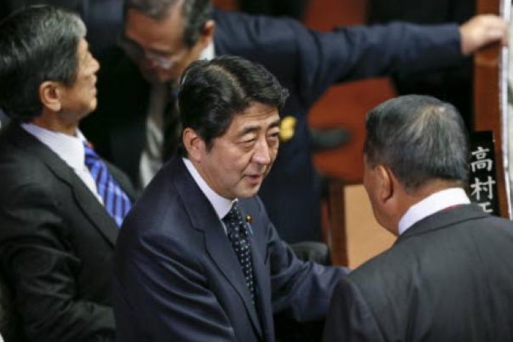 Biggest opposition Liberal Democratic Party president and former prime minister Shinzo Abe (centre) talks with the party's senior members at Japan's Lower House in Tokyo on Friday. Photo: EPA
