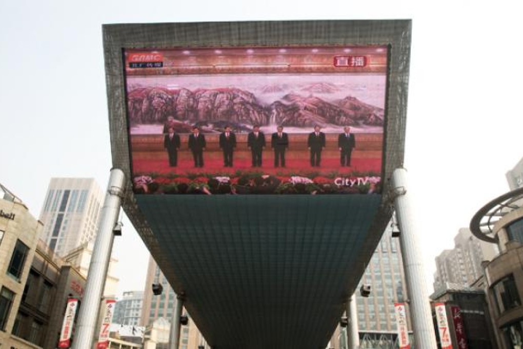 A huge TV screen shows a live broadcast of China's new seven-member Standing Committee, the inner circle of Chinese political power, on Thursday. Photo: AP