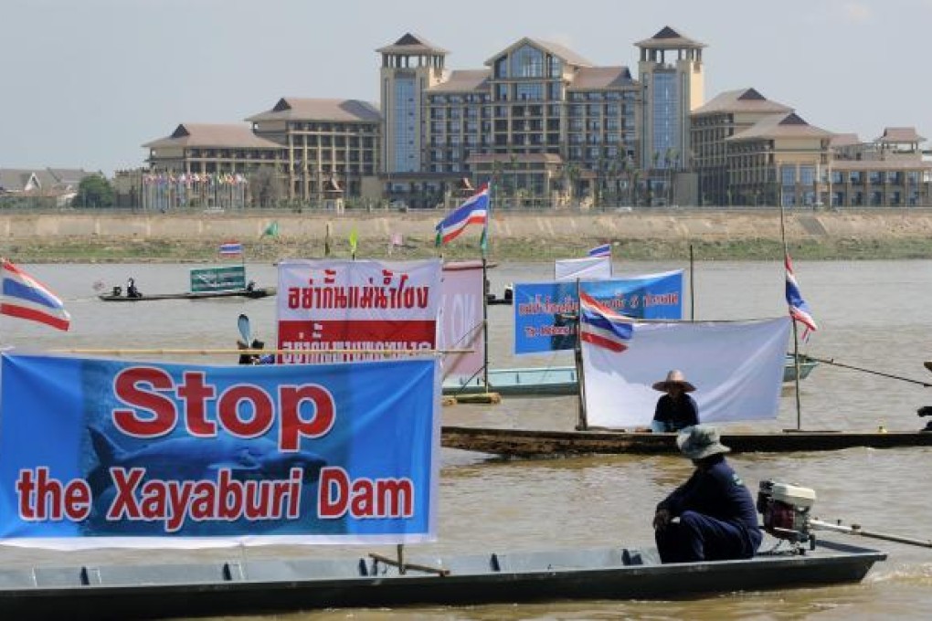 Thai activists and villagers protest opposite Laos. Photo: EPA