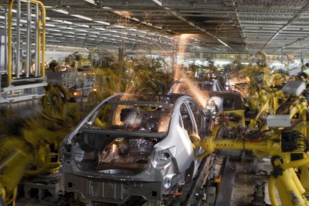 Robots work on the welding line at a Hyundai Motor plant in Beijing. Factory wages are going up as manufacturers struggle to find staff. Photo: Bloomberg