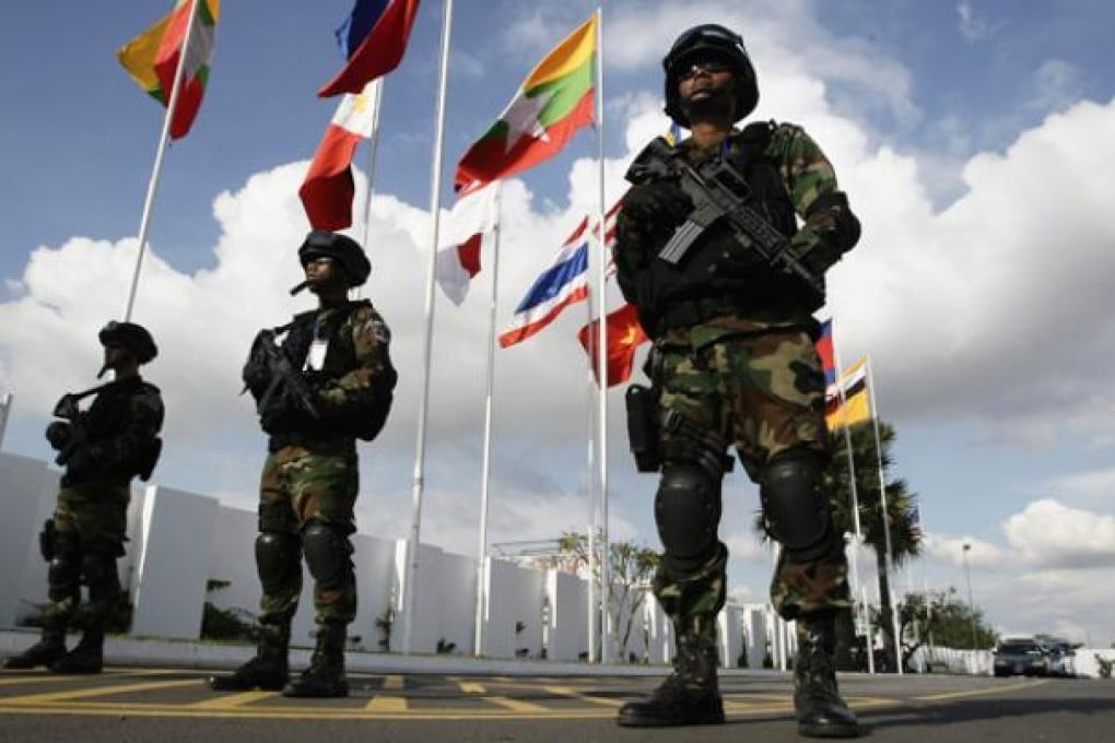 Cambodian securities personnel stand guard at Phnom Penh International Airport ahead of the 21st of Association of Southeast Asian Nations Summit on Saturday. Photo: AP