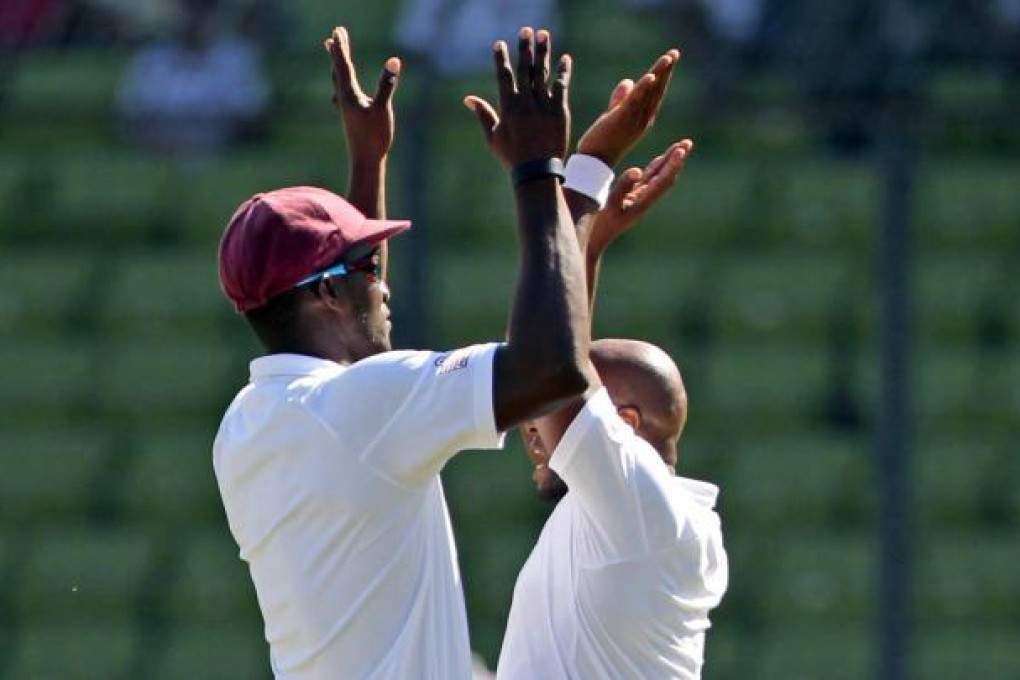 Tino Best (right) and Darren Sammy celebrate. Photo: AP