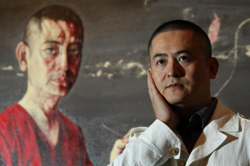 Zeng Fanzhi poses next to one of his paintings. Photo: May Tse