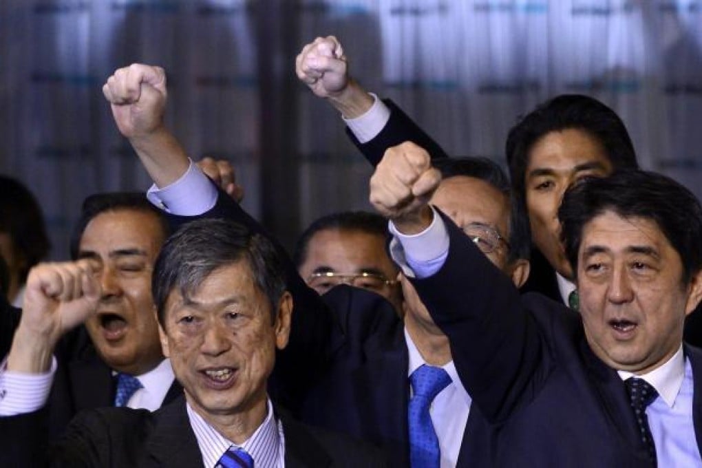 Shinzo Abe (far right), who is in the running for prime minister, chants slogans with party members yesterday. Photo: EPA