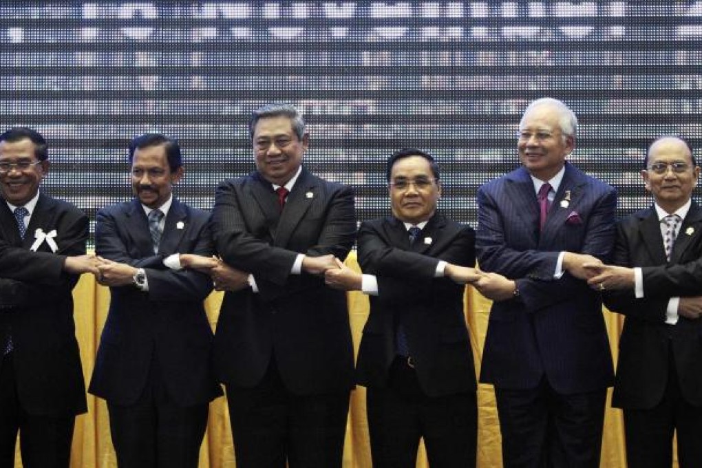 Asean leaders hold hands during the opening ceremony of the 21st Asean and East Asia summits in Phnom Penh. Photo: Reuters