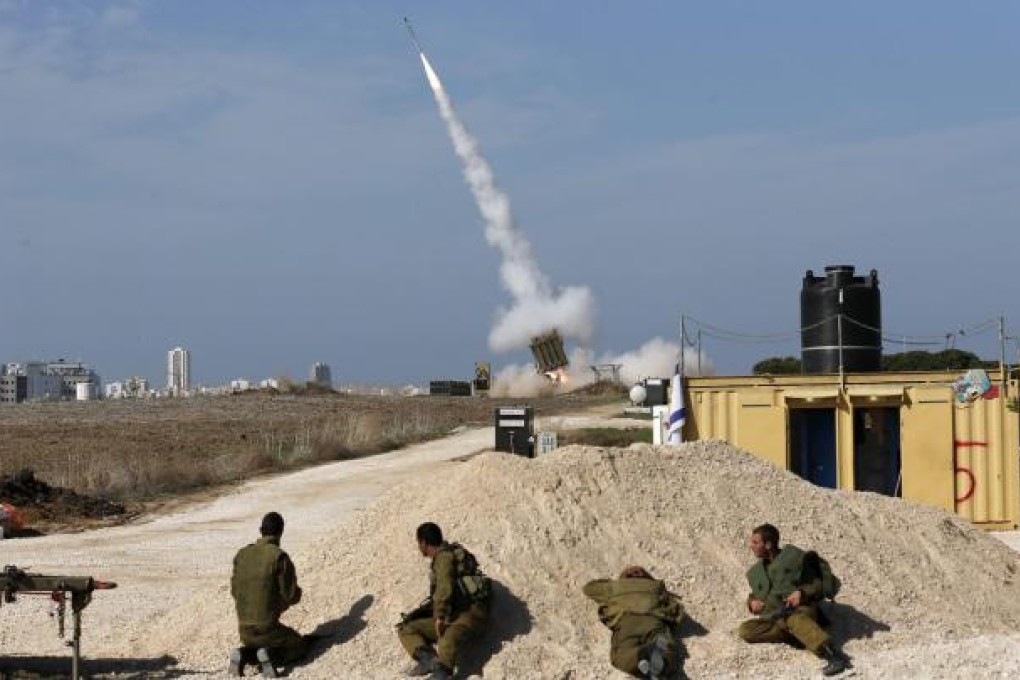 Israeli soldiers watch as an Iron Dome launcher fires an interceptor rocket near the southern city of Ashdod. Photo: Reuters