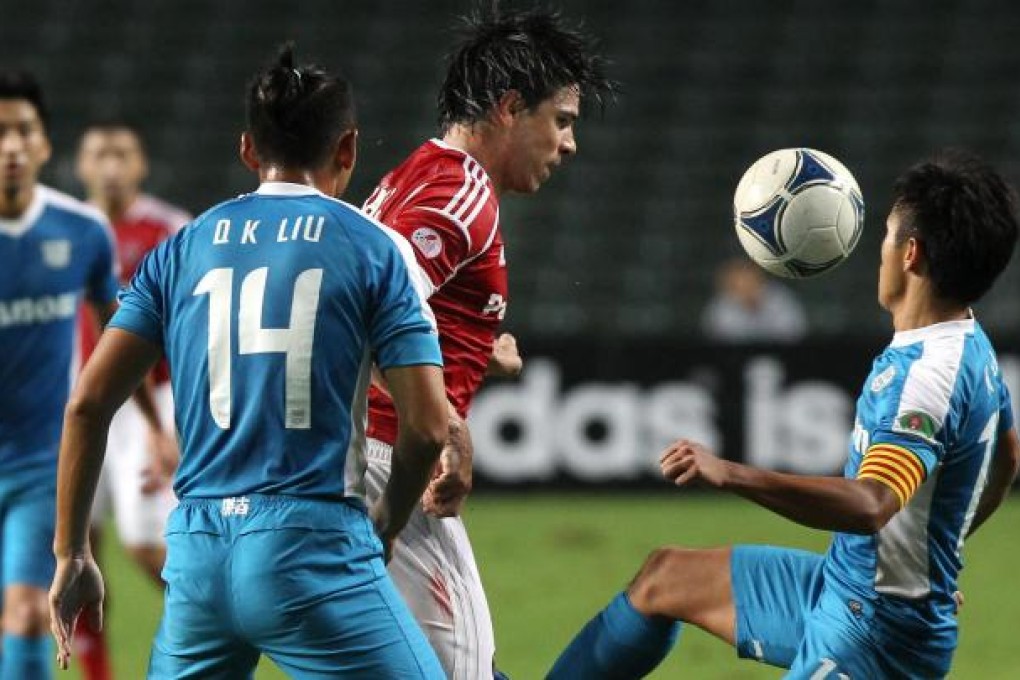South China's Mauro da Silva tries to beat the challenges of Kitchee defender Liu Quankun and captain Lo Kwan-yee. Photo: Sam Tsang