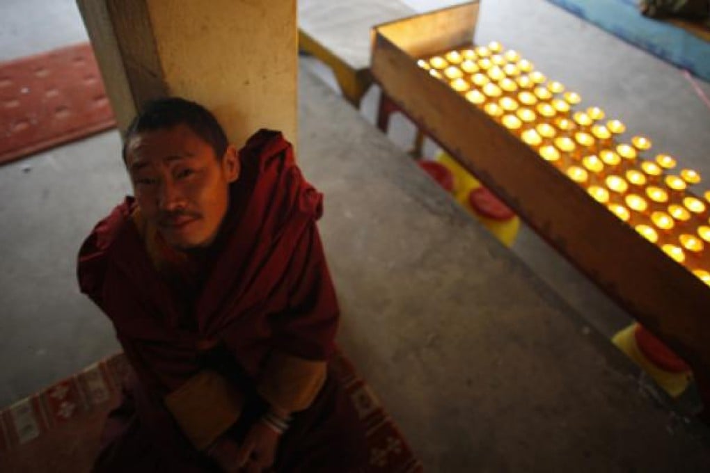 An exiled Tibetan monk waits in Katmandu, India, on Saturday for the start of a prayers to display solidarity towards Tibetans who have self-immolated protesting China's rule over Tibet. Photo: AP