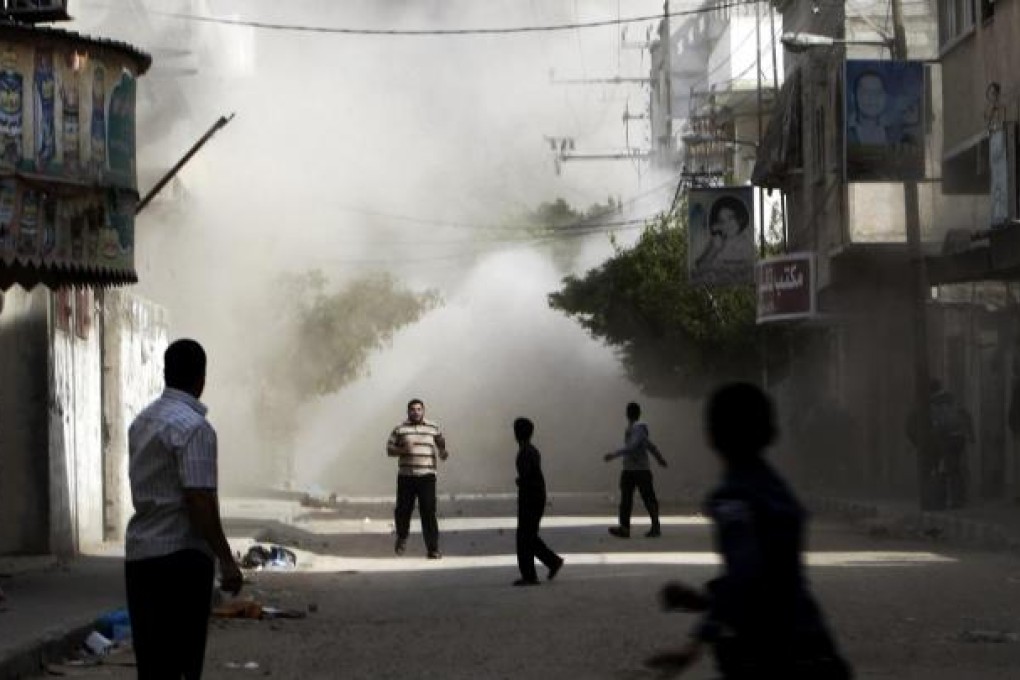 A building in Gaza is hit during an Israeli air strike. Photo: AP