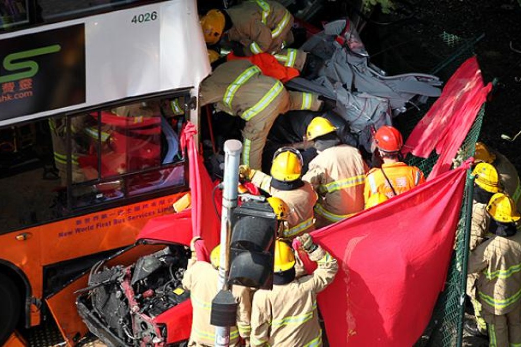 Firefighters and paramedics try release passengers trapped in a taxi after a pile-up in Shau Kei Wan on Monday. Photo: Thomas Yau