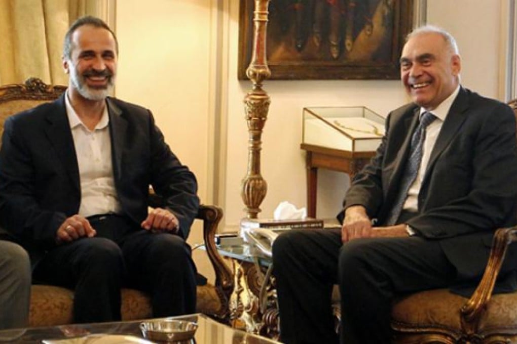 Head of the National Coalition of Forces of the Syrian Revolution and Opposition, Ahmad Mouaz al-Khatib (left), meets with Egyptian Foreign Minister, Mohammed Kamel Amr, in Cairo, Egypt, on Monday. Photo: EPA