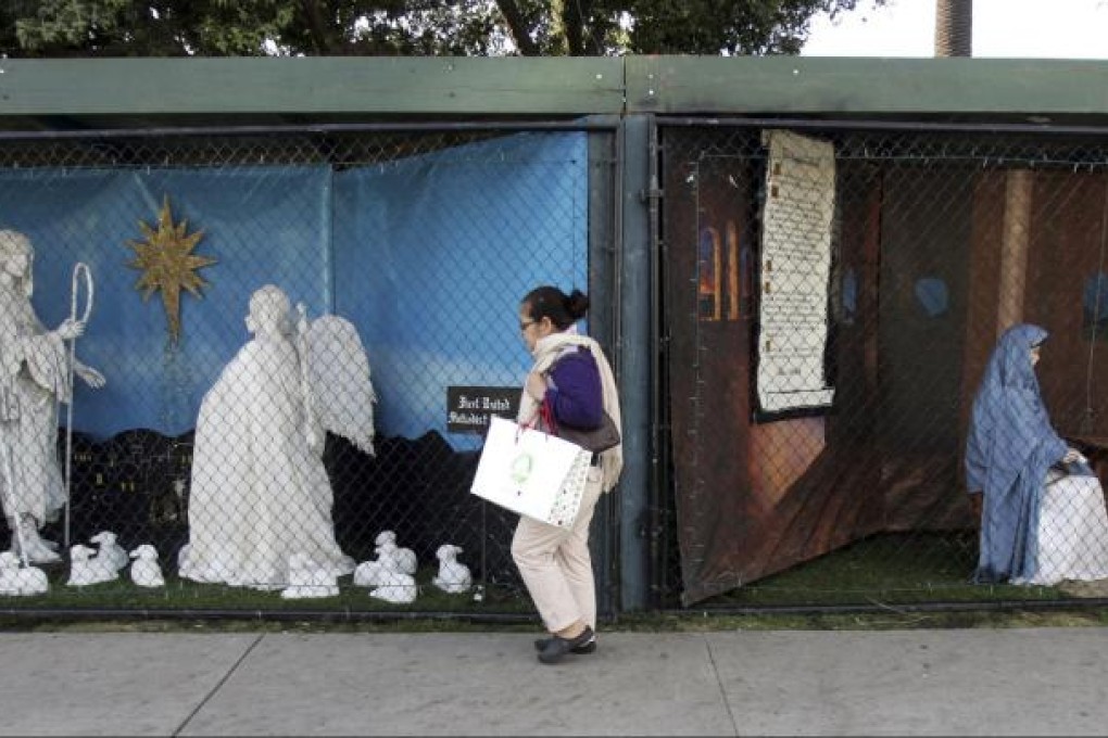 A woman walks past Christian displays in the Santa Monica park. Photo: AP