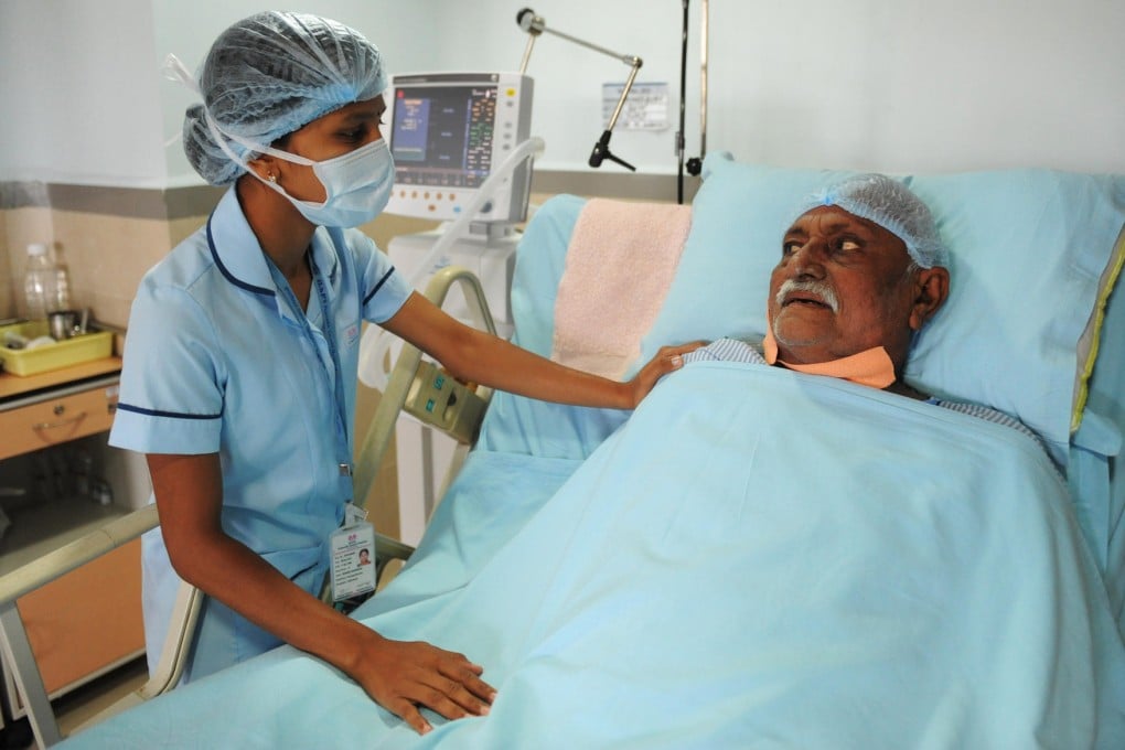 A nurse attends to a patient in the ICU ward at a hospital in Ahmedabad, India.Photo: AFP