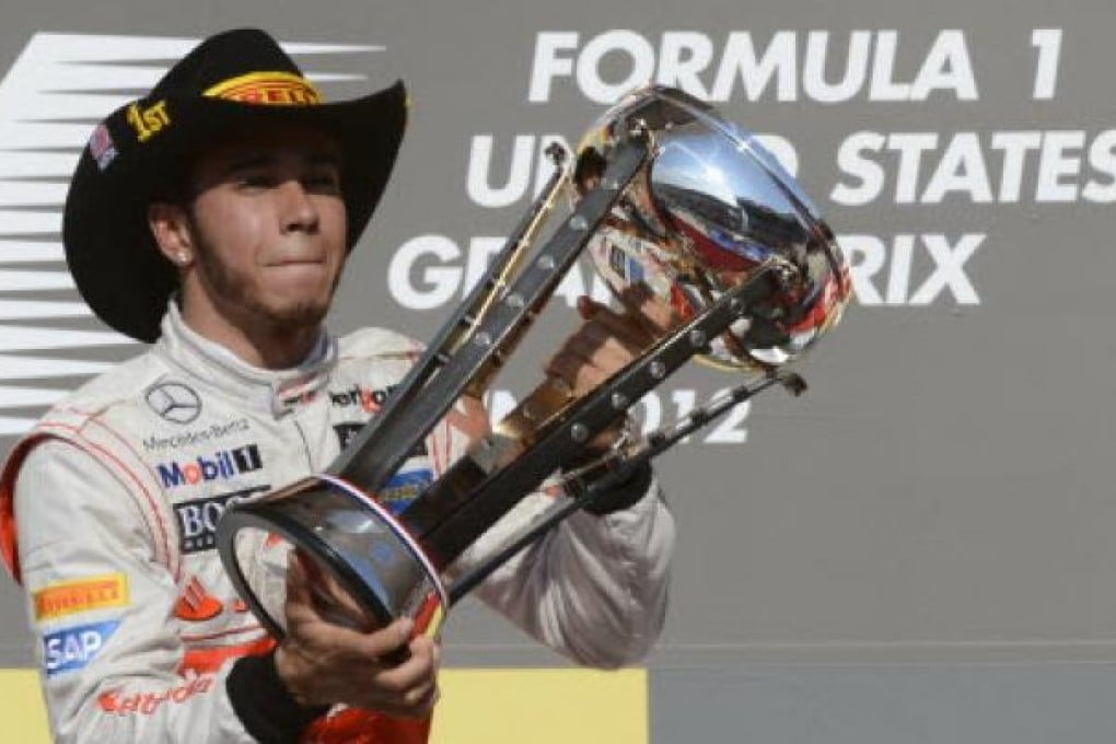 Vodafone McLaren Mercedes driver Lewis Hamilton of Britain celebrates on the podium after winning the United States Formula One Grand Prix at the Circuit of the Americas on Sunday. Photo: AFP