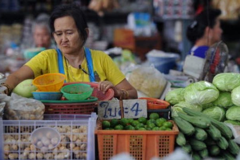 Thailand's central bank upgraded its forecast for the kingdom's economic growth this year, predicting an expansion of 6.0 percent thanks to a recovery from last year's massive floods. (AFP/PORNCHAI KITTIWONGSAKUL)