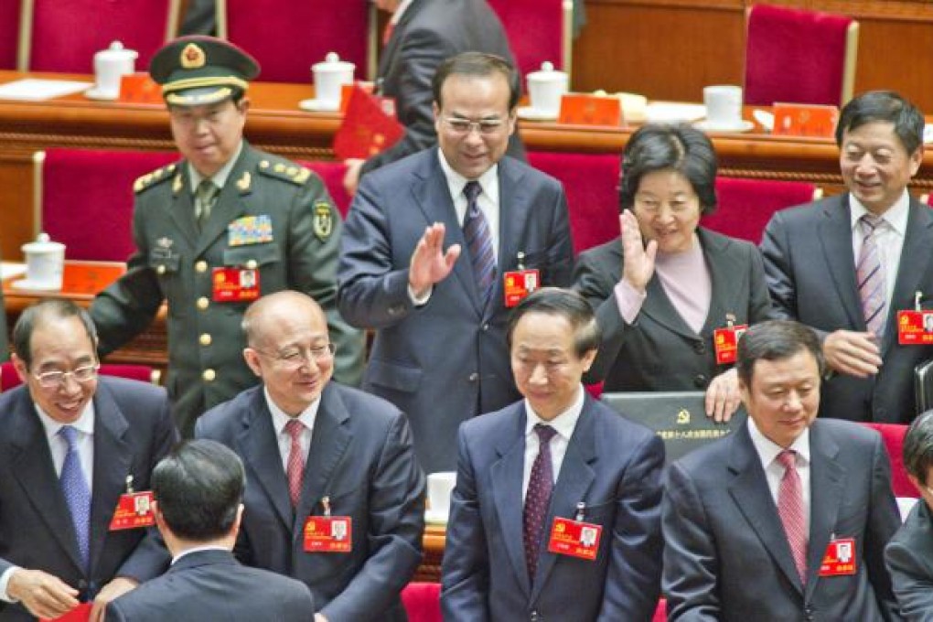 Sun Zhengcai (second left, back) waves Hu Jintao as the president meets delegates at last week's party congress. Photo: Simon Song