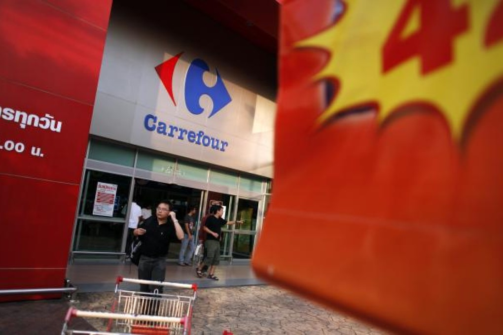Shoppers leave a Carrefour supermarket in central Bangkok January 22, 2011. A battle between large supermarket operators to tap into Southeast Asia's growing consumer wealth could trigger more acquisitions, with Indonesia, Vietnam and the Philippines seen as the next hot spots. ( REUTERS/Damir Sagolj)